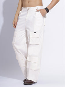 White cargo pants displayed folded, focusing on the smooth fabric and design details