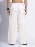 Back view of white cargo pants, highlighting sturdy stitching and deep pockets.