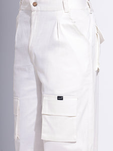 Close-up of cargo pocket detail on the white pants, showing durable fabric and secure fasteners.