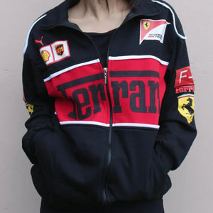 A sleek, fitted women's black Ferrari F1 jacket with the iconic Ferrari logo on the chest, featuring a zip-up front and bold racing accents.